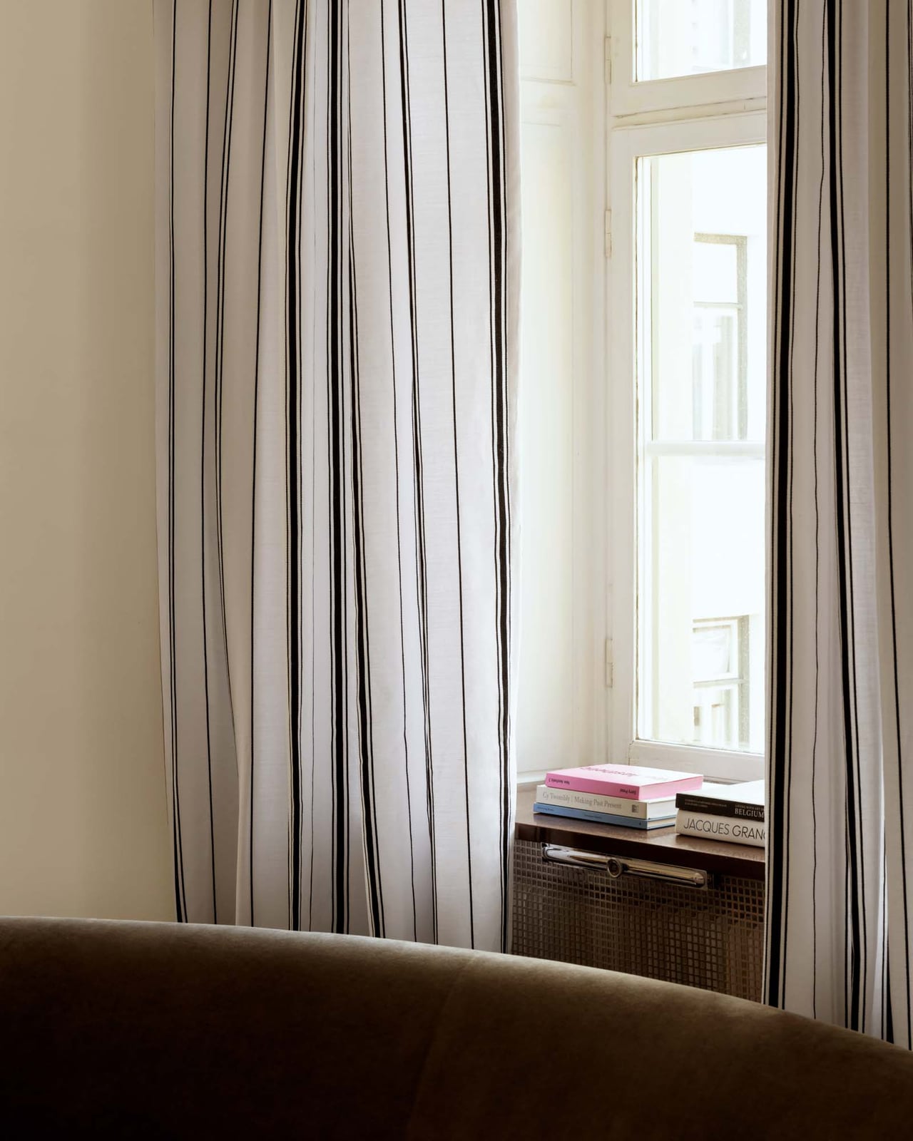 The Triple Stripe curtain in Dusty White/Black with a textured linen-cotton weave and natural drape, styled by a window.