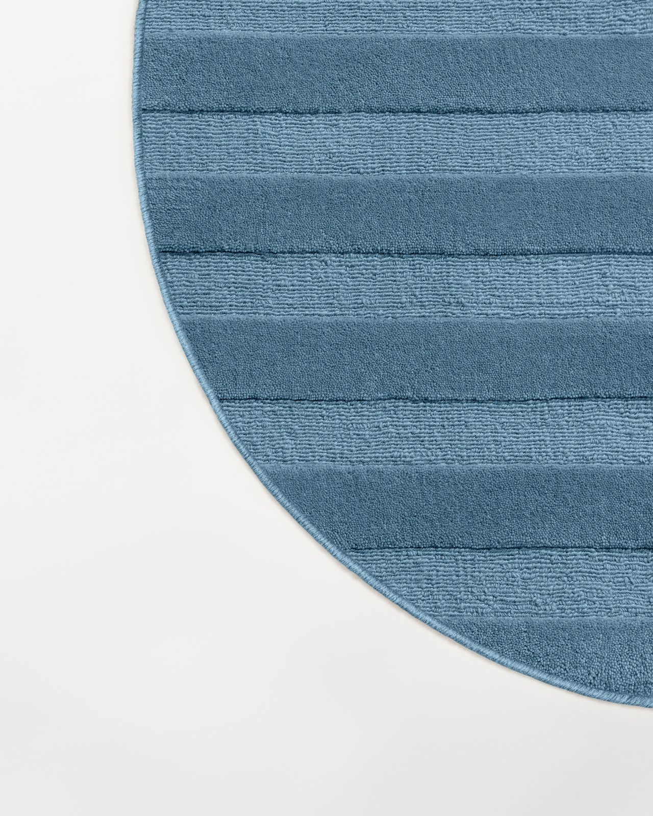 Close-up of the Park 03 - Steel Blue - Custom US Size custom rug, showing its curved edge and plush, linear texture.