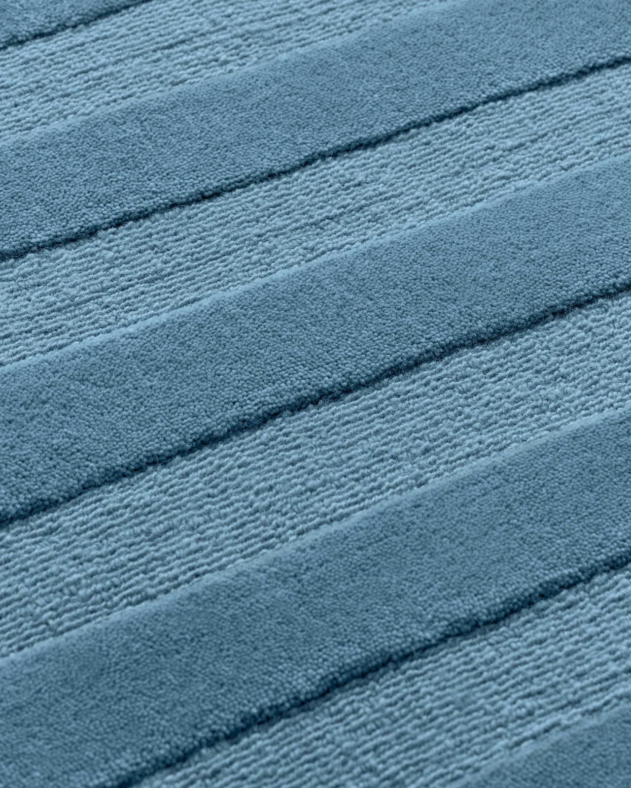 Close-up of the Park 03 - Steel Blue - Custom US Size custom rug, showing the round edge and dense loop and cut pile.
